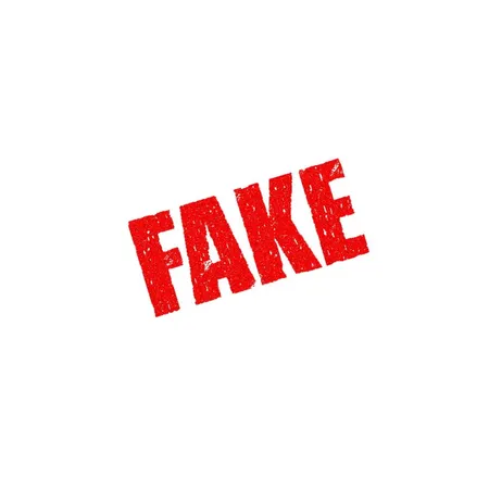 Red word 'FAKE' written on a white wall Red word 'FAKE' written on a white wall