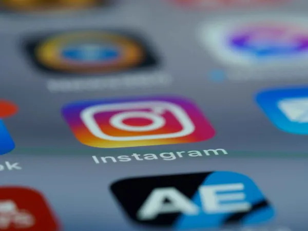 A smartphone screen displays the Instagram logo A smartphone screen displays the Instagram logo